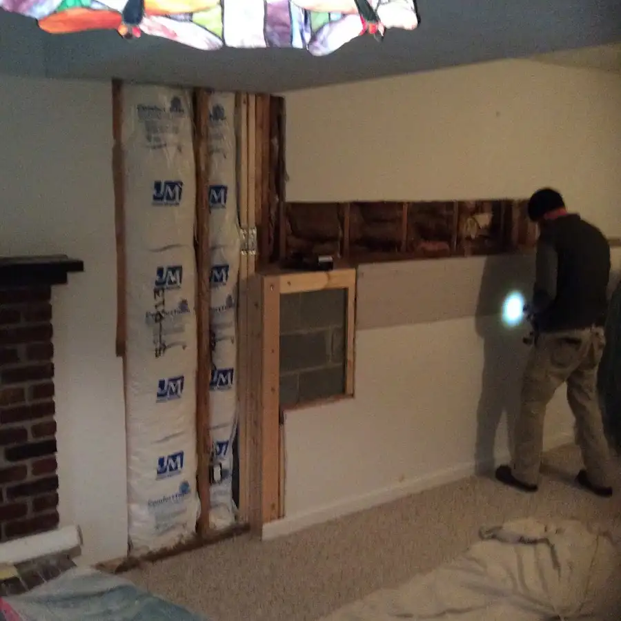 Restoration technician inspecting water damage in Covington